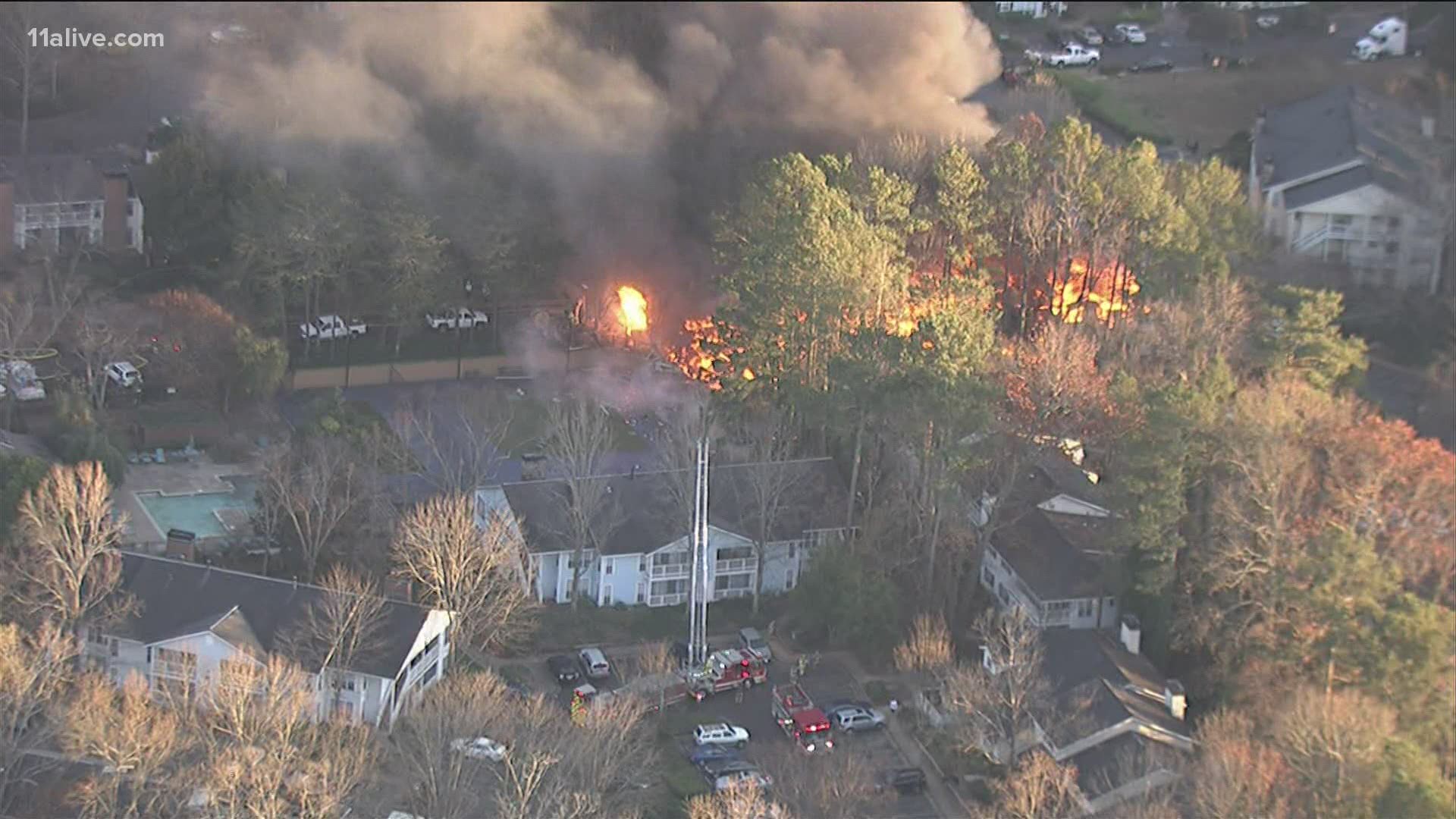 The explosion and fire burned at least one apartment building to the ground.