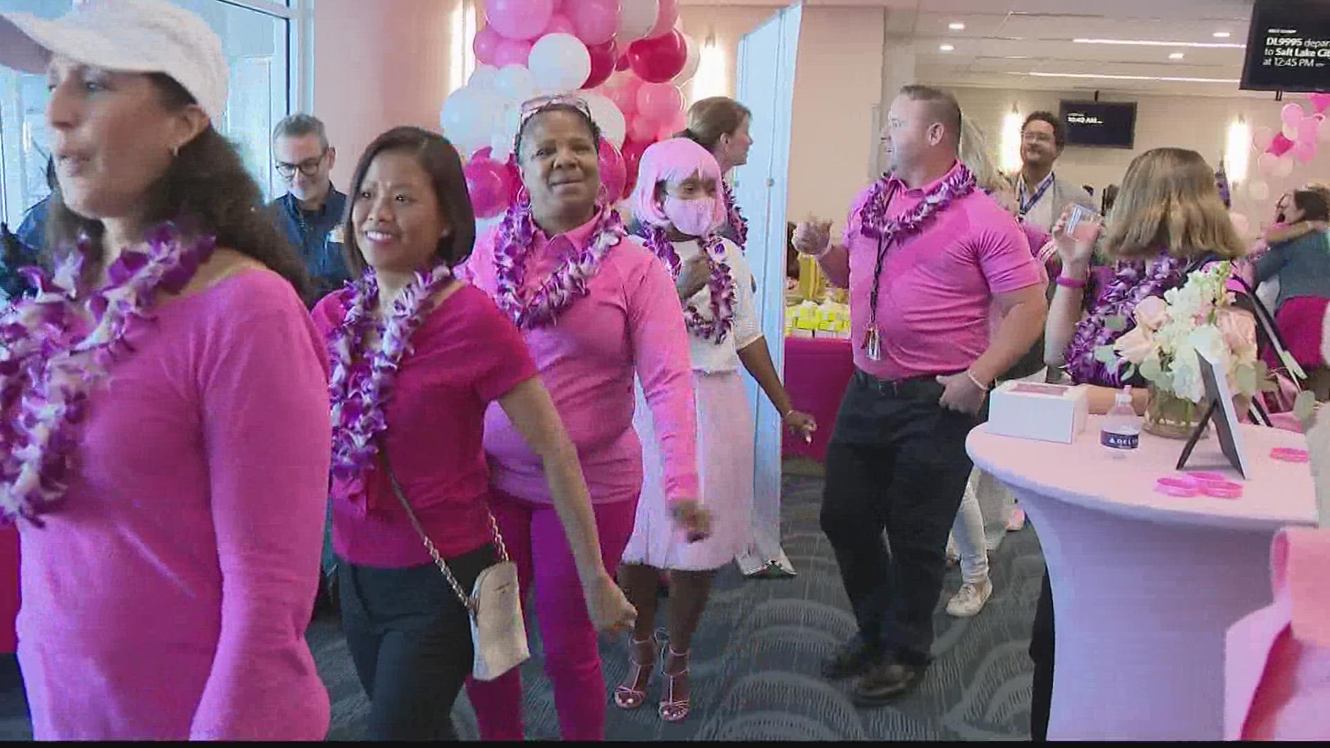 Survivors and employees put on their pink and hopped on board Delta's "Breaks Cancer One Flight."