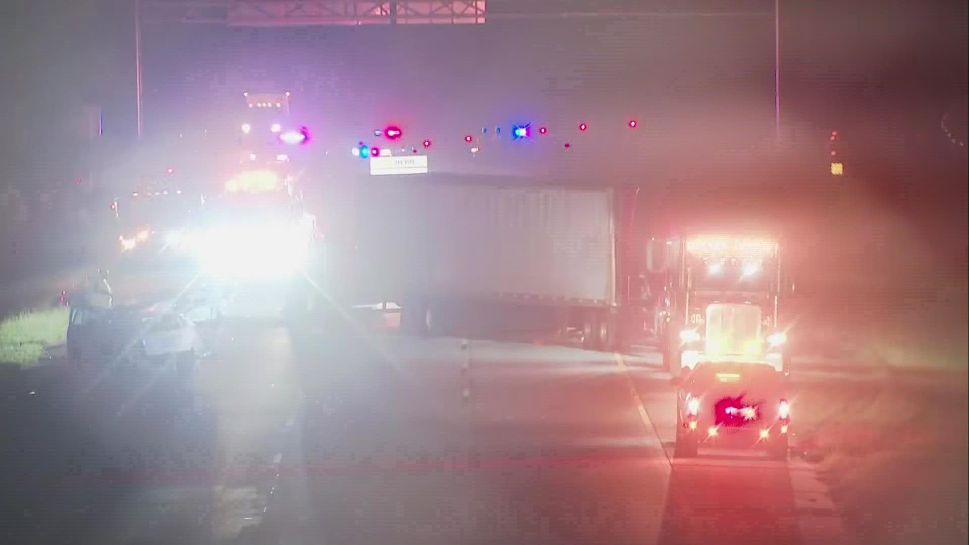 One person is dead and another injured after a tractor-trailer crashed into a sedan that was stopped on the right shoulder of I-675 northbound Thursday night.