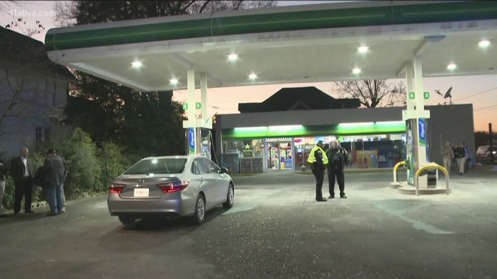 An officer was shot and woman killed after a confrontation in front of the BP gas station in Calhoun at the corner of Wall and E Line streets.