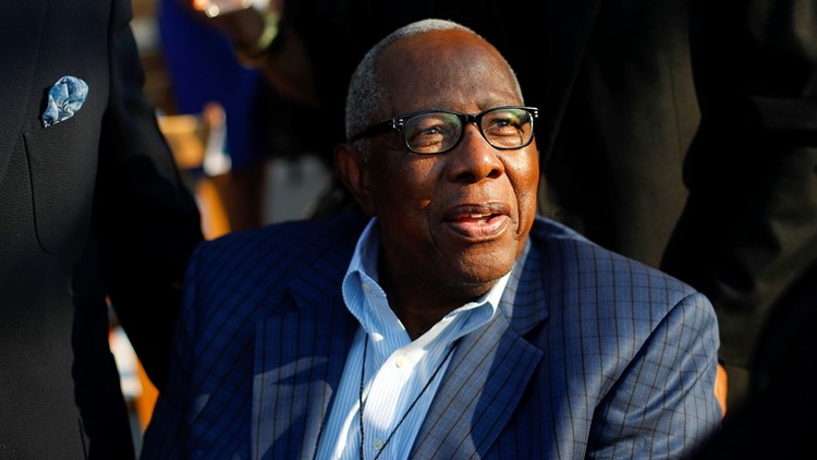 FILE - In this Sept. 30, 1969, file photo, a Major League Baseball 100th  anniversary patch is shown on the uniform of Atlanta Braves team captain  Hank Aaron, left, as he watches