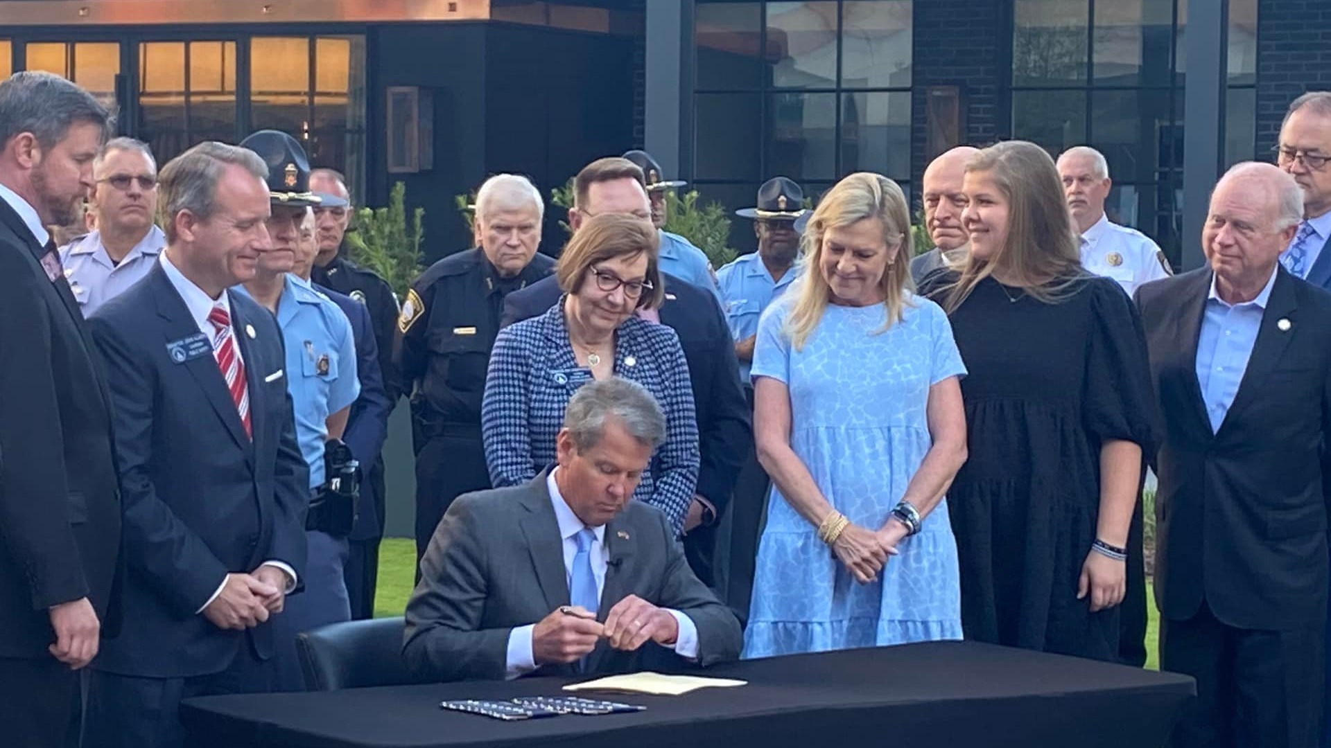 Georgia Governor Brian Kemp signed seven new bills into law on Monday surrounded by dozens of law enforcement officials.