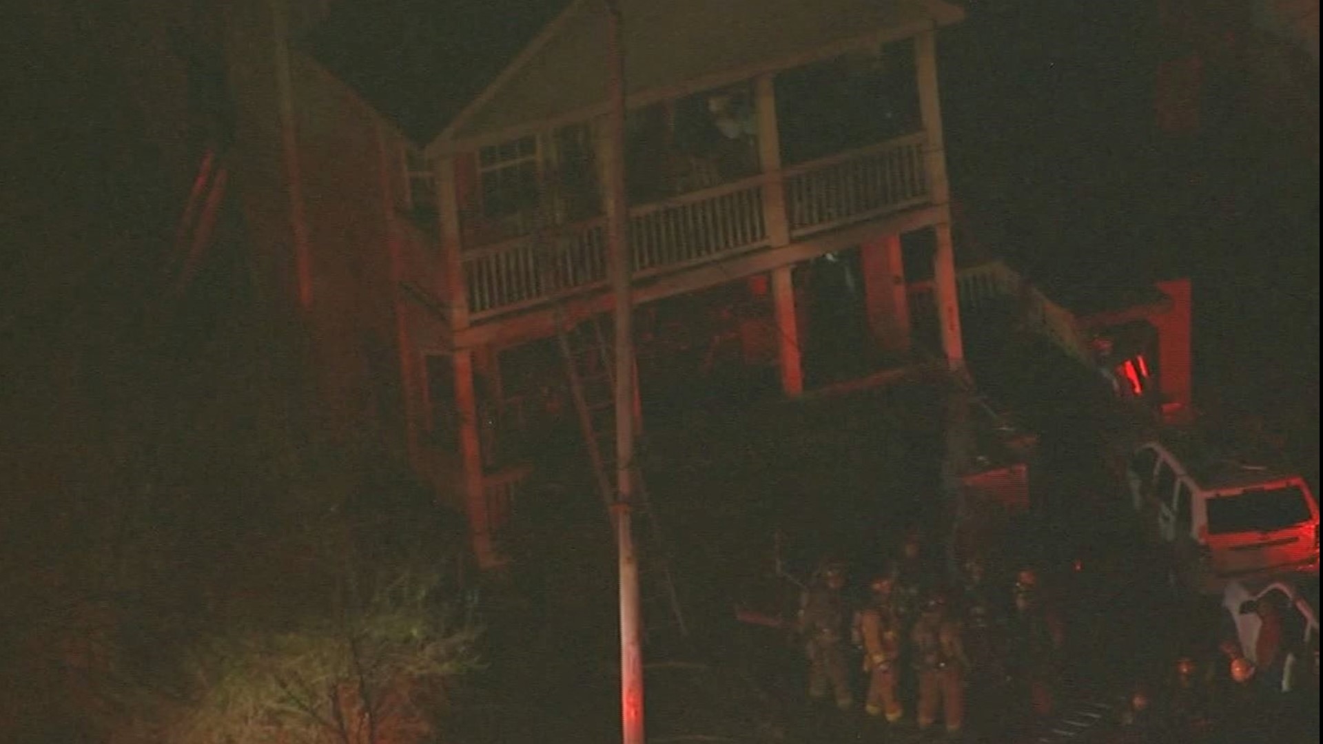 Firefighters are working to learn what sparked a fire at an Atlanta home that forced people, including four children, to climb down the side of a balcony.