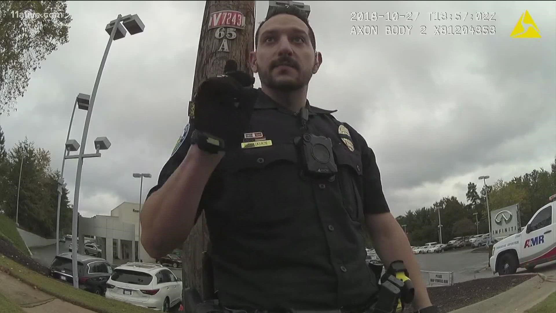 Body camera and patrol car recordings show officer Daniel MacKenzie tasing and punching a handcuffed man.