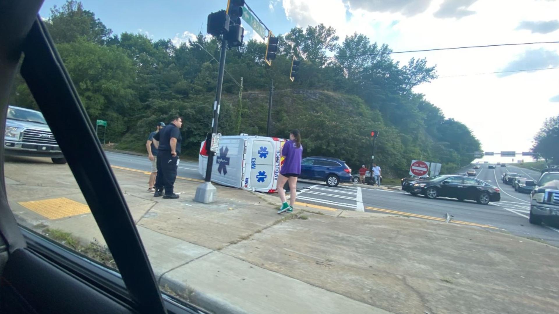 An ambulance flipped over on its side after being involved in a crash near I-85 in DeKalb County on Saturday, police said.