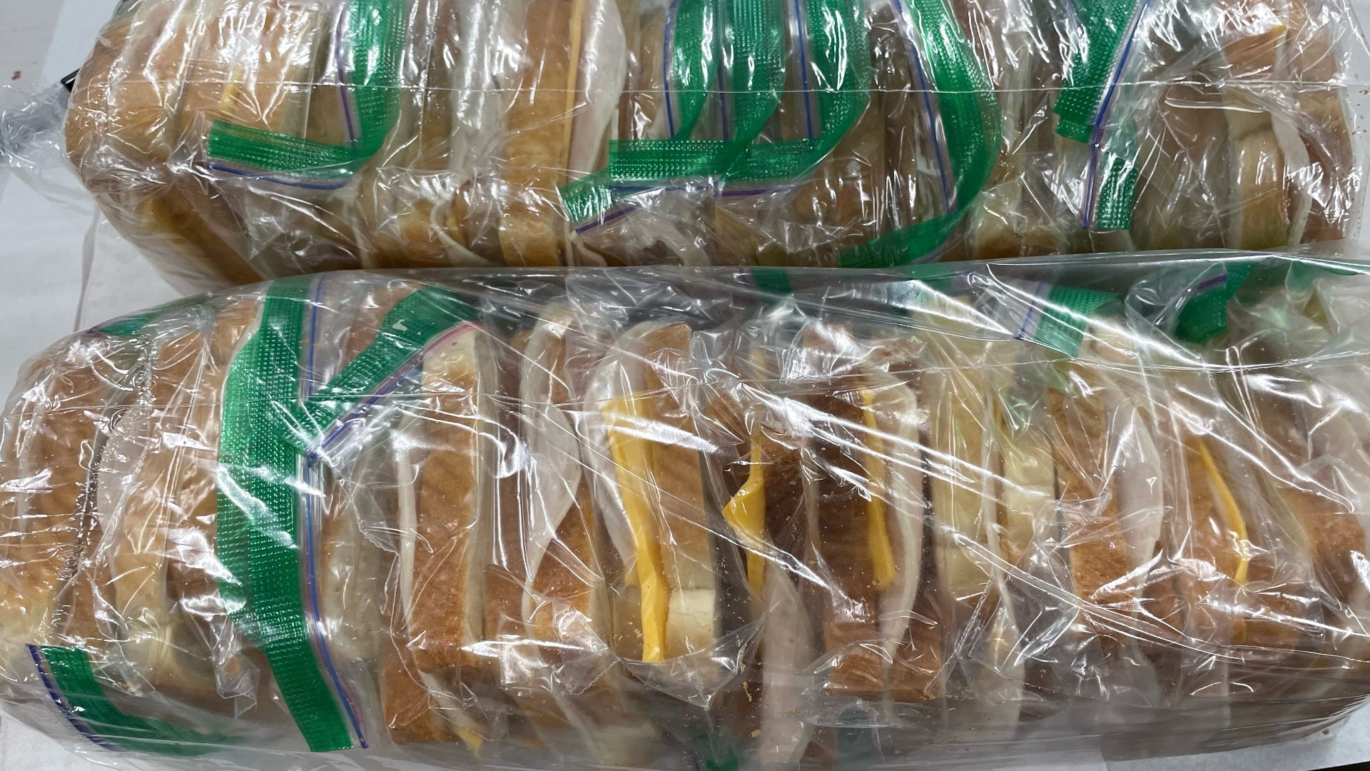 Volunteers serve a little bit of love in between two slices of bread.