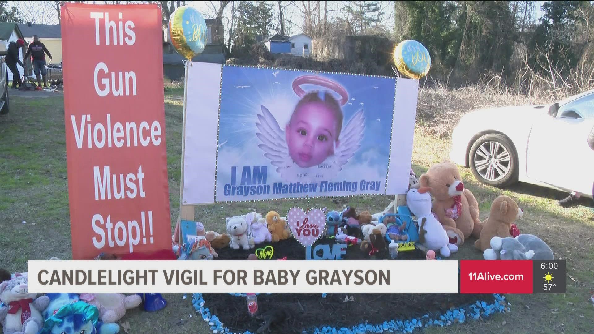 A candlelight vigil was held for Grayson Fleming Gray, a 6-month-old killed after getting caught in the crossfire of a shooting last week.