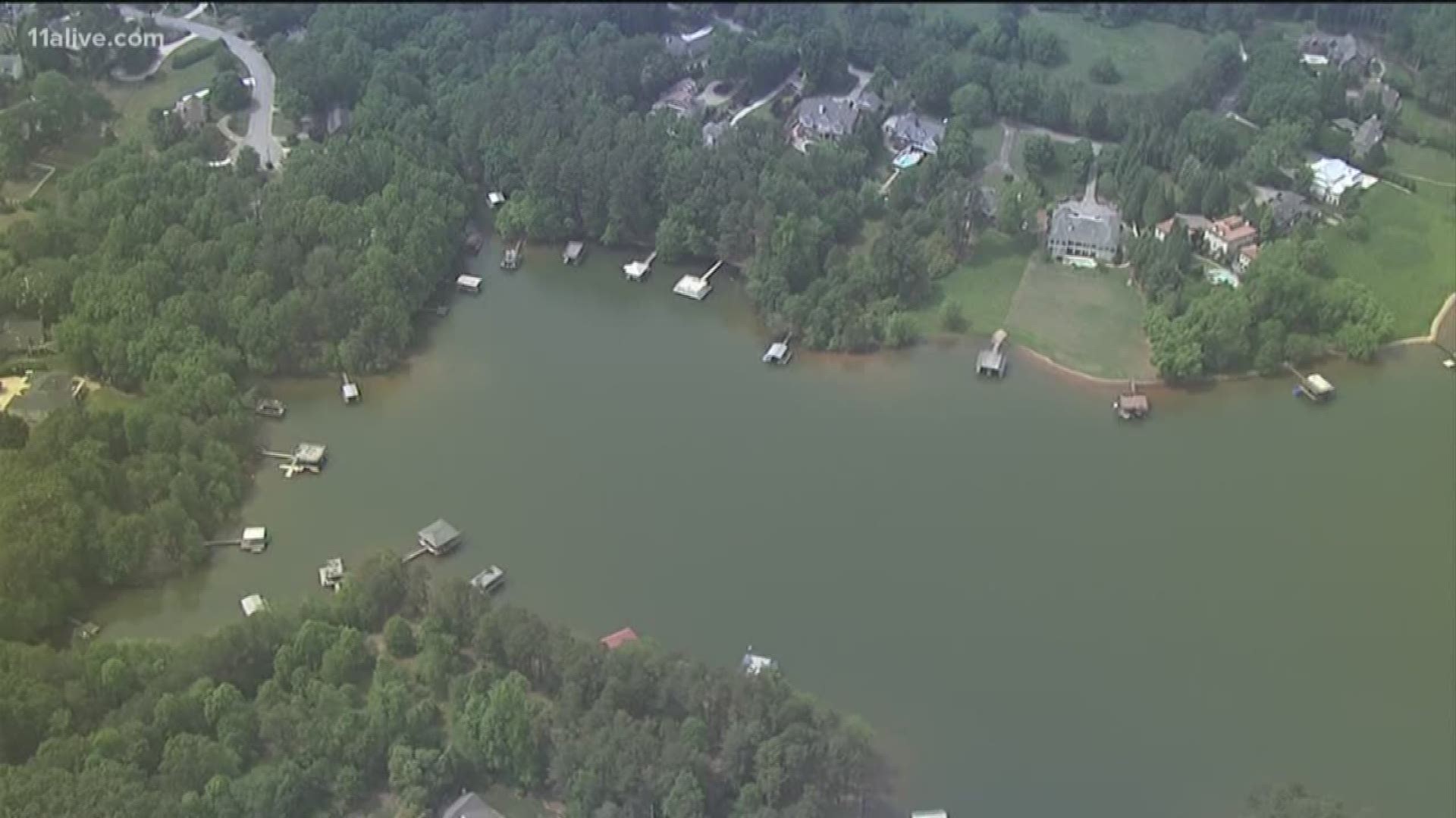 A son and emergency responders were unable to save a man investigators believe fell off a dock into Lake Lanier on Saturday.