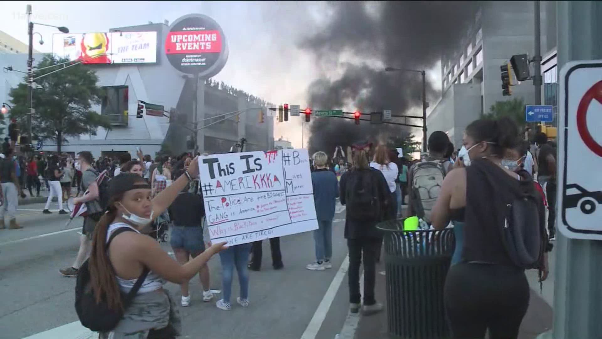 Police have begun making arrests and crowds are still in the area around the burning car.