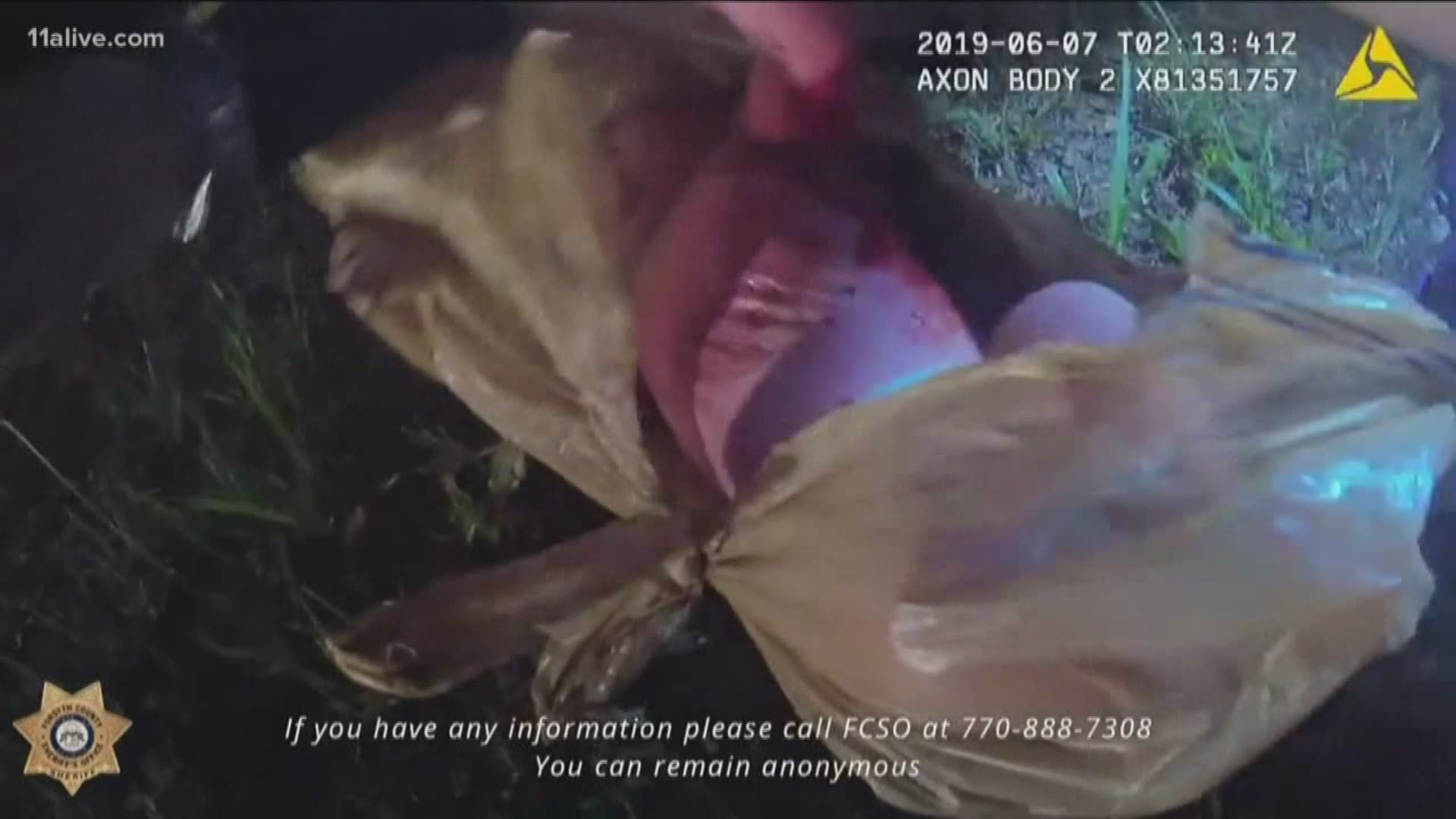 The body cam video shows the moments the baby was found wrapped in the plastic bag.