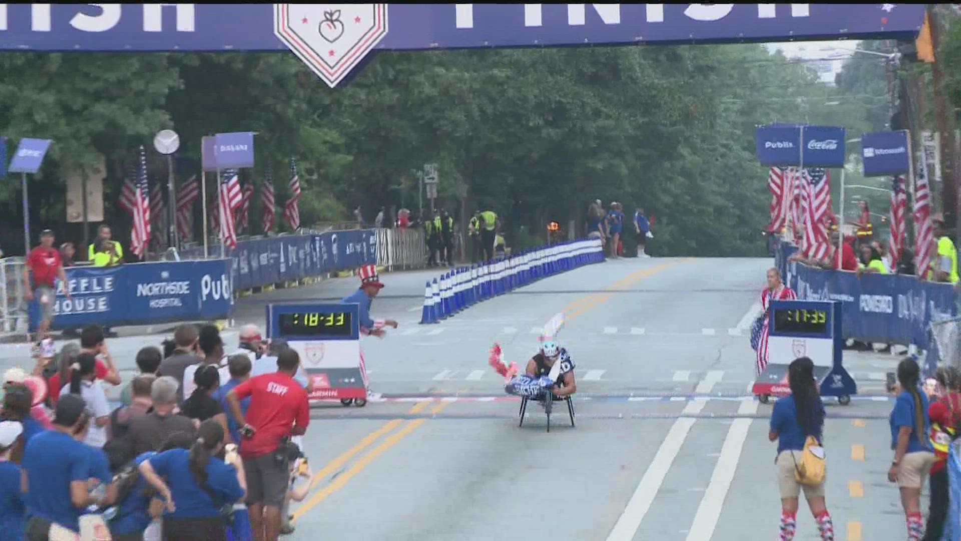 Watch as the first person cross in the finish line in the men's wheelchair race.