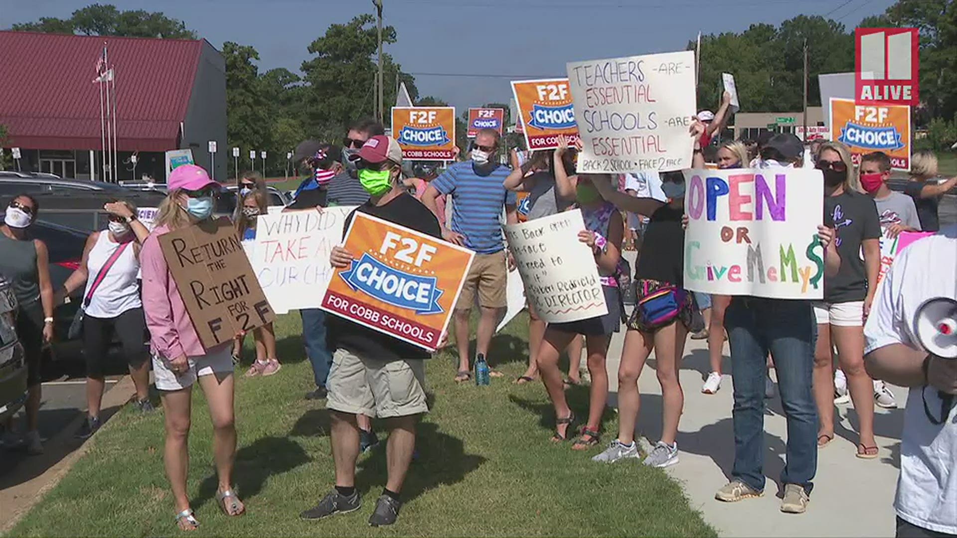 Dozens showed up outside in Marietta late Saturday morning to protest the Cobb Schools' decision for an online-only start to the school year.
