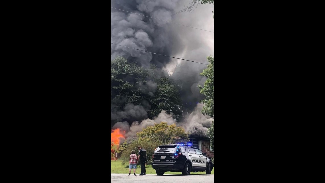 Smyrna house fire burns as officer prays with homeowner