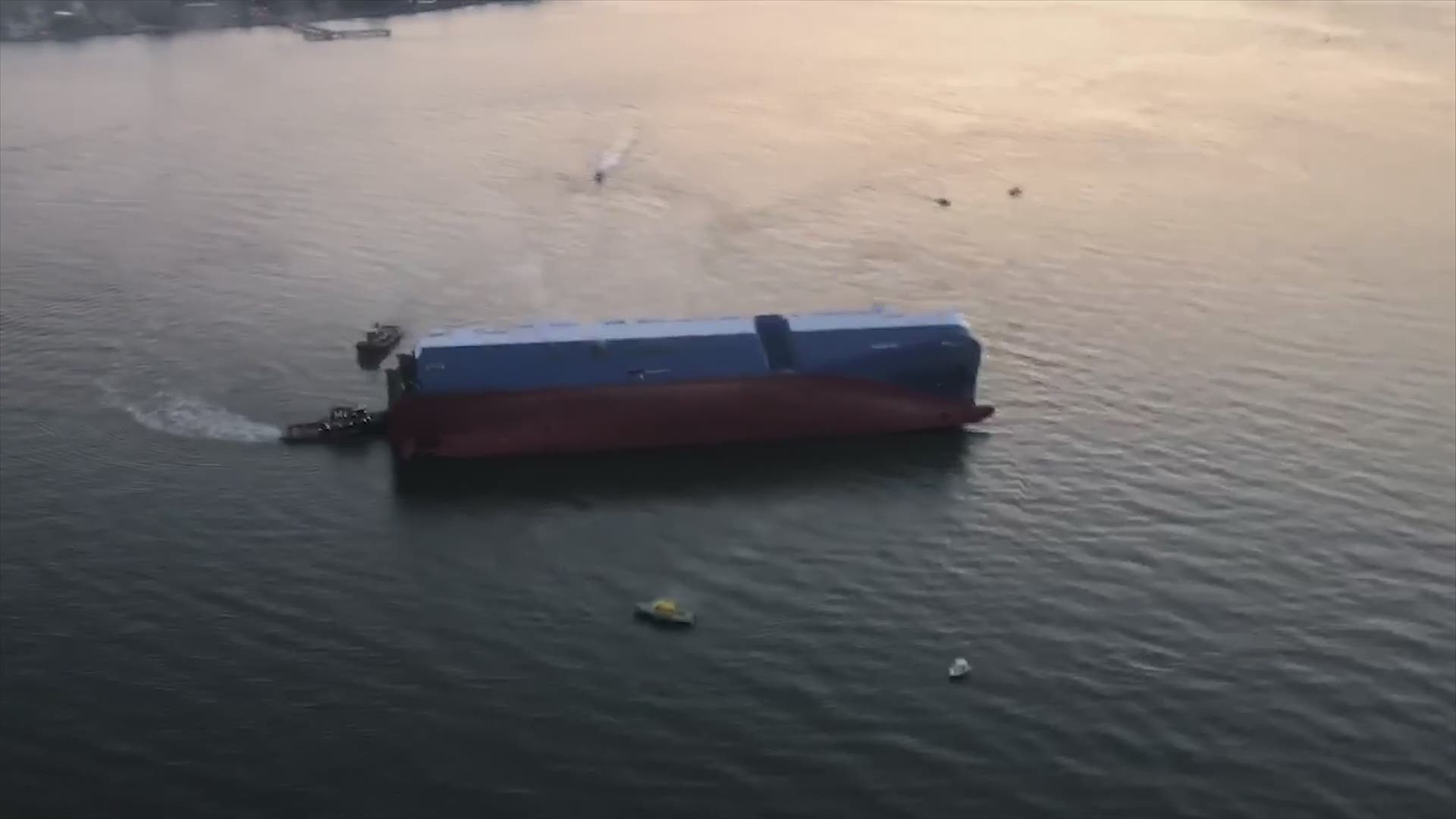 Video from above shows the Golden Ray ship on its side in the St. Simons Sound, near Brunswick, Georgia. The Coast Guard rescued 20 people from the ship, but four are still missing.