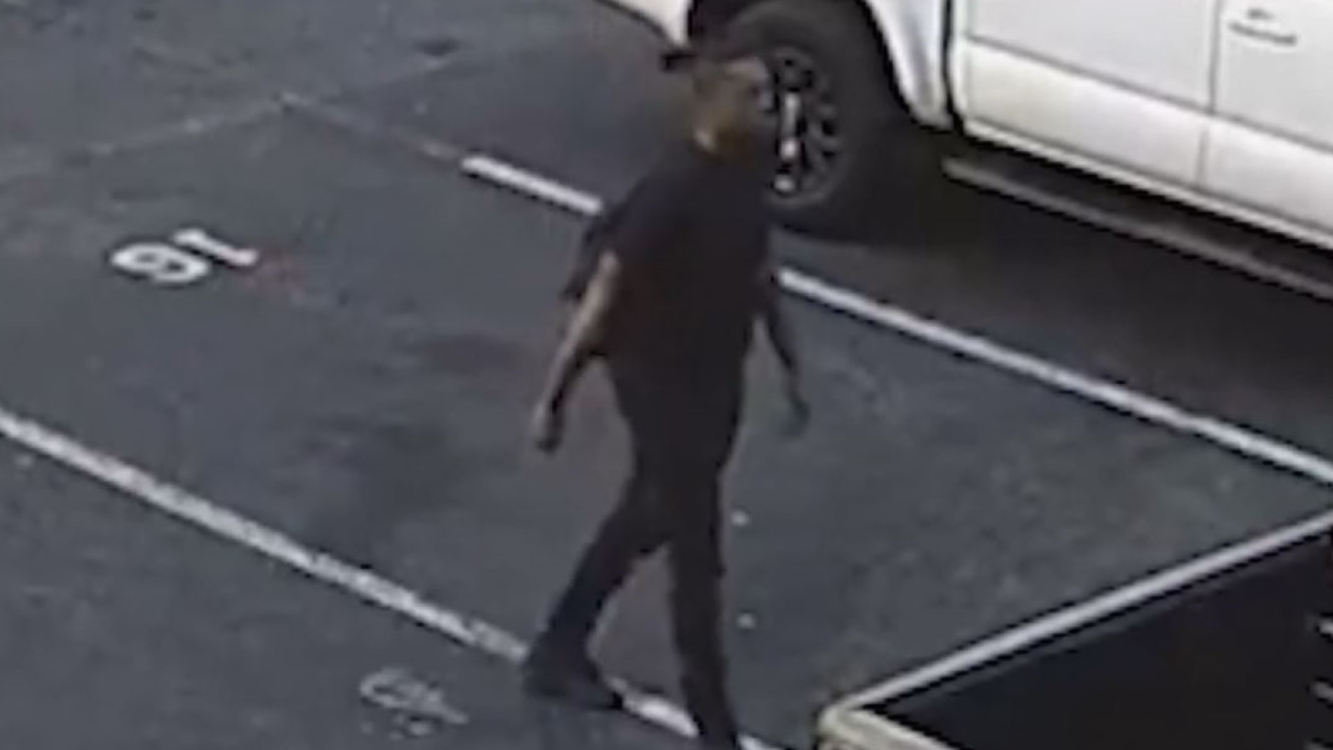 Video shows him leaving a black pick-up truck and walking across the parking lot across to a black SUV.