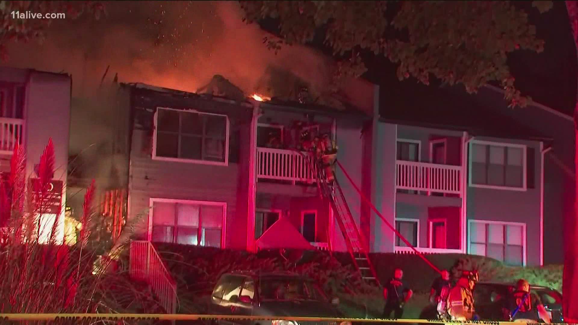 Flames ripped through the roof and rooms of the apartment complex.