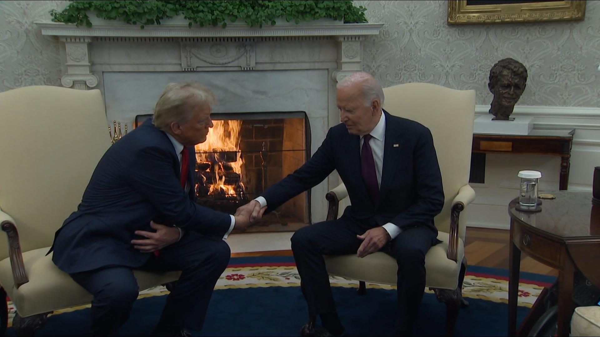 Cameras captured the two shaking hands in a symbolic gesture to the transfer of power.