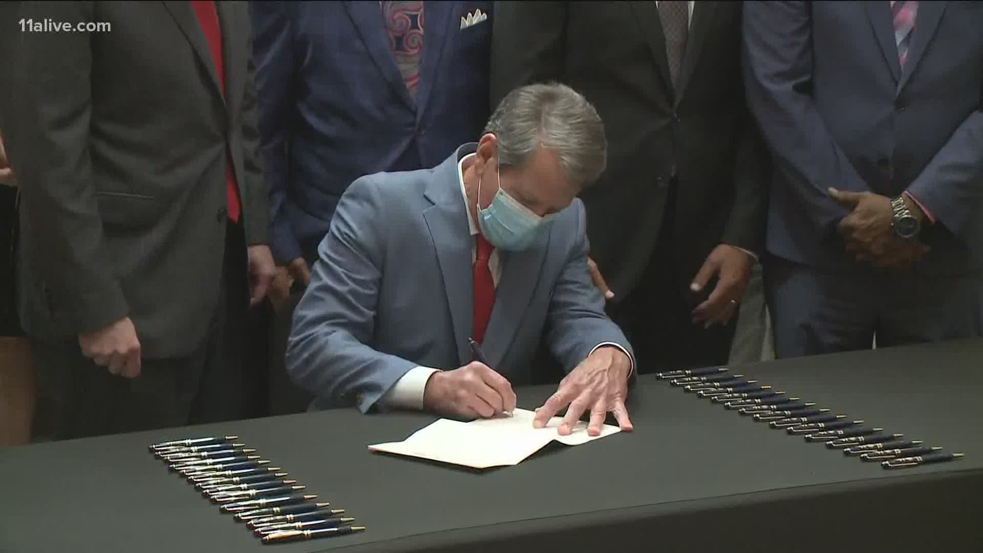 Gov. Kemp was backed by a bipartisan group of lawmakers as he signed the bill on Friday.