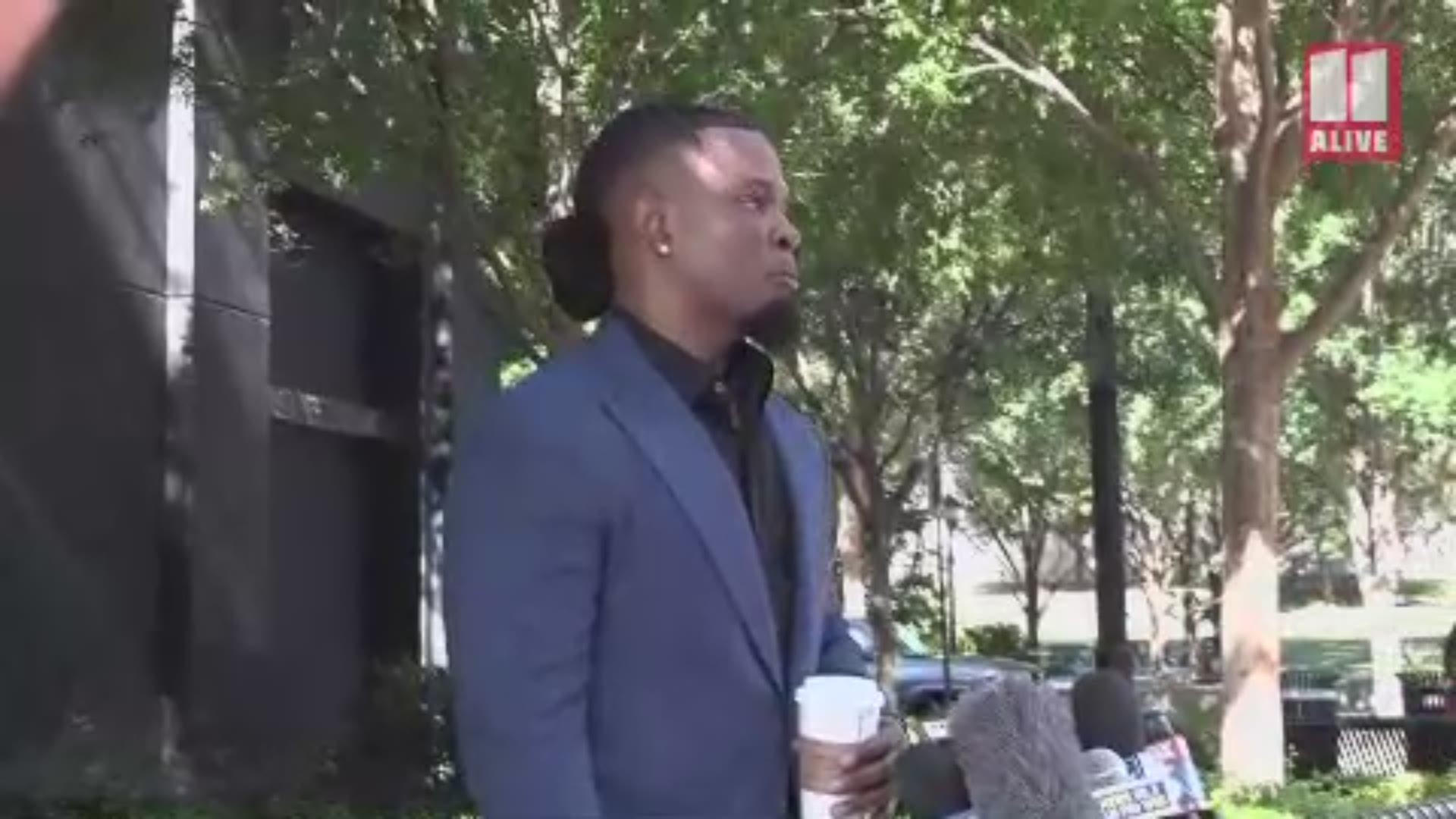 Darrell Johnson was giving a press conference on Friday in Atlanta in the wake of R. Kelly's arrest on federal charges when the family of Jocelyn Savage confronted him.