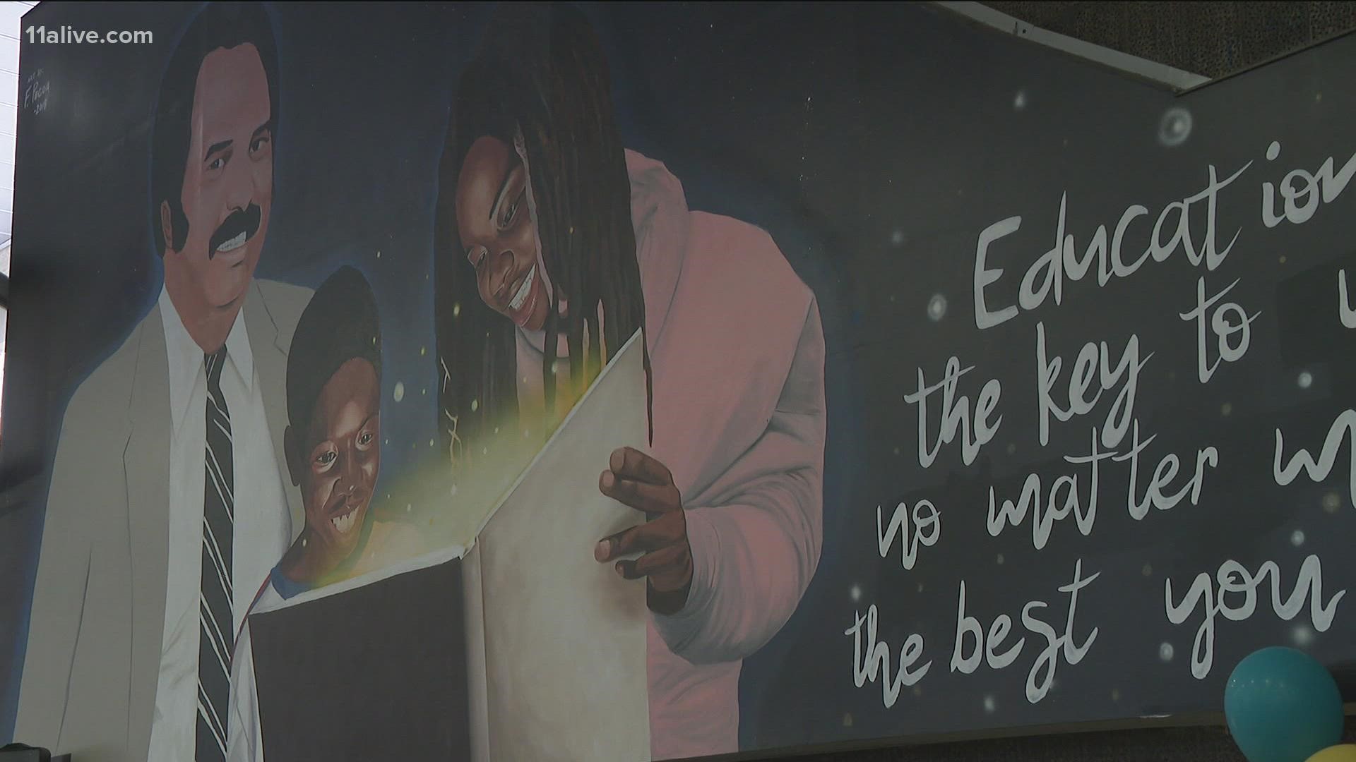 The mural celebrates the life of Dr. Holmes and his accomplishments.