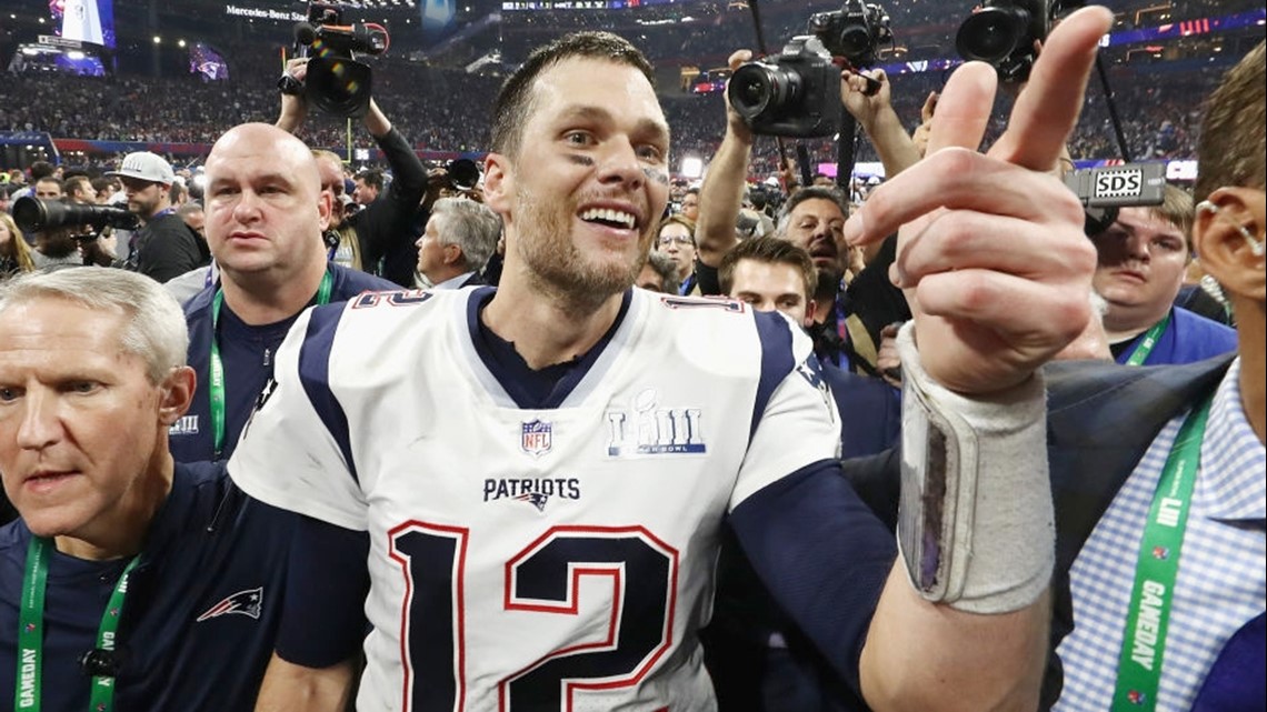 New England Patriots quarterbacks Tom Brady (L) and Brian Hoyer (R)  celebrate before defeating the Los Angeles Rams 13-3 in Super Bowl LIII at  Mercedes-Benz Stadium in Atlanta on February 3, 2019.