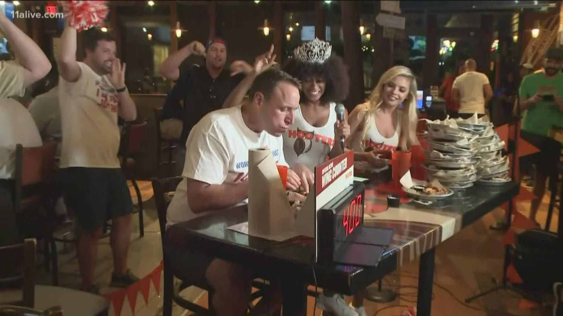 Joey Chestnut pulled up a chair at the Mall of Georgia Hooters for a marathon chicken-wing-eating display on Monday.