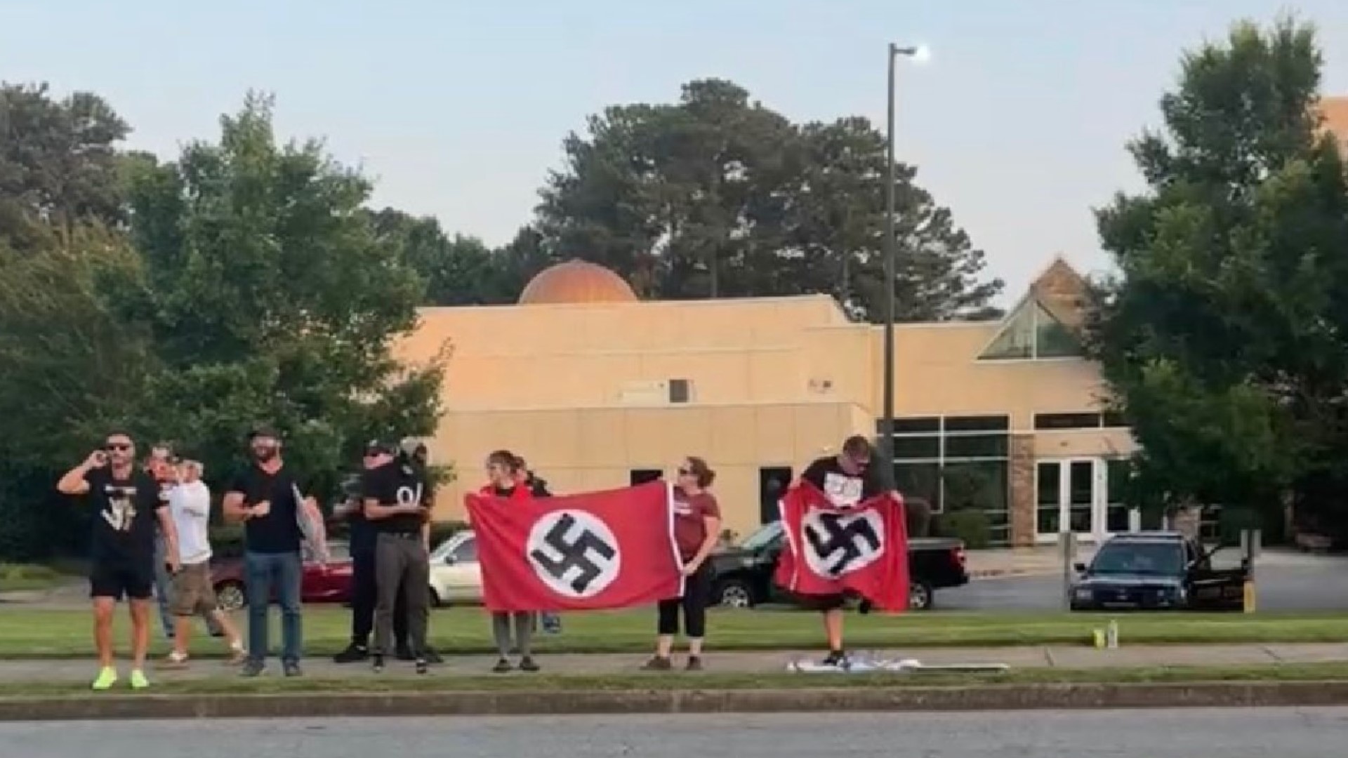 Photos shared on social media show demonstrators even going as far as waving Nazi flags.