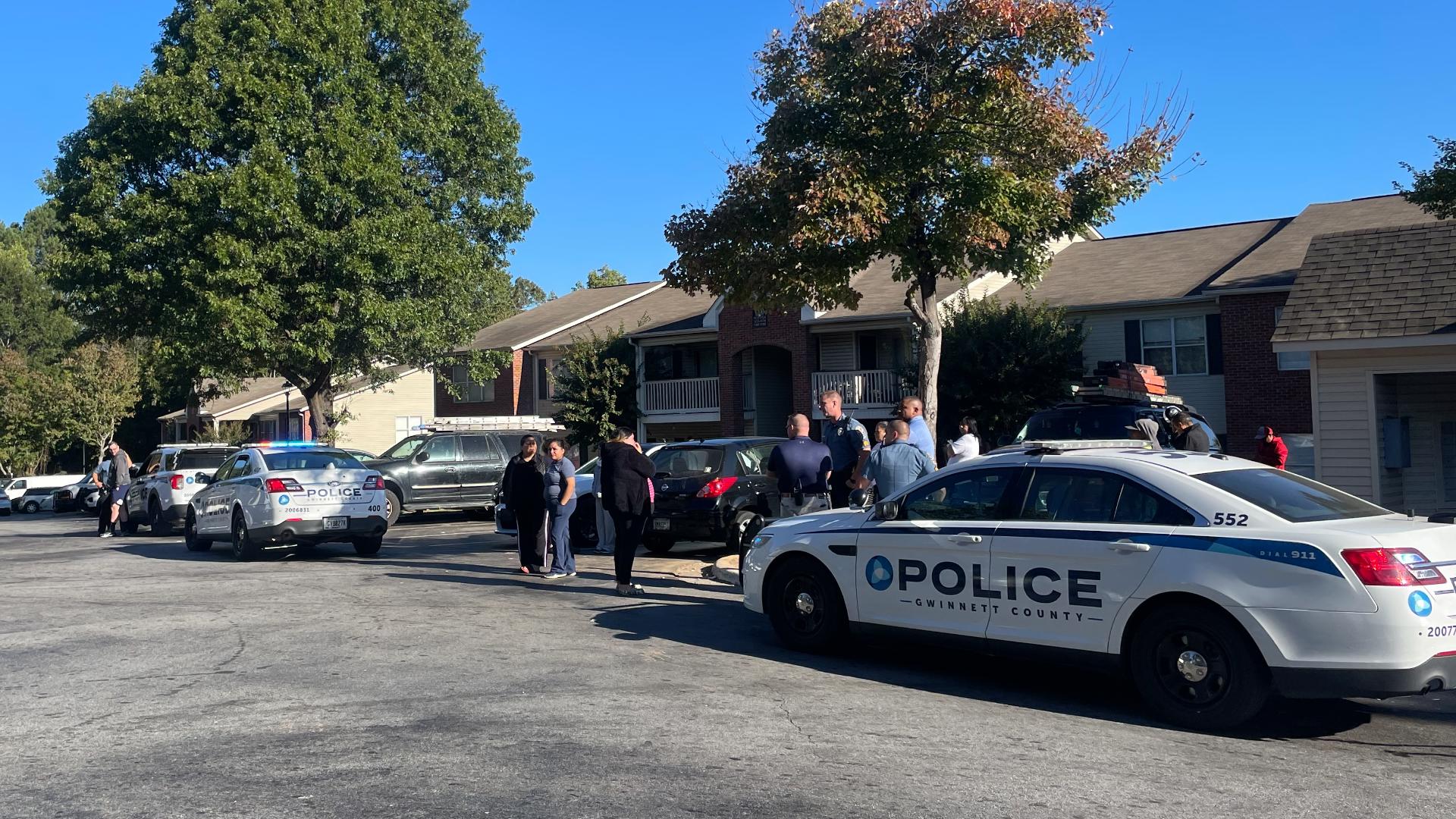 A woman is dead and a suspect is on the run after a shooting at an apartment complex along Gwinnett Station Circle on Monday, police said.