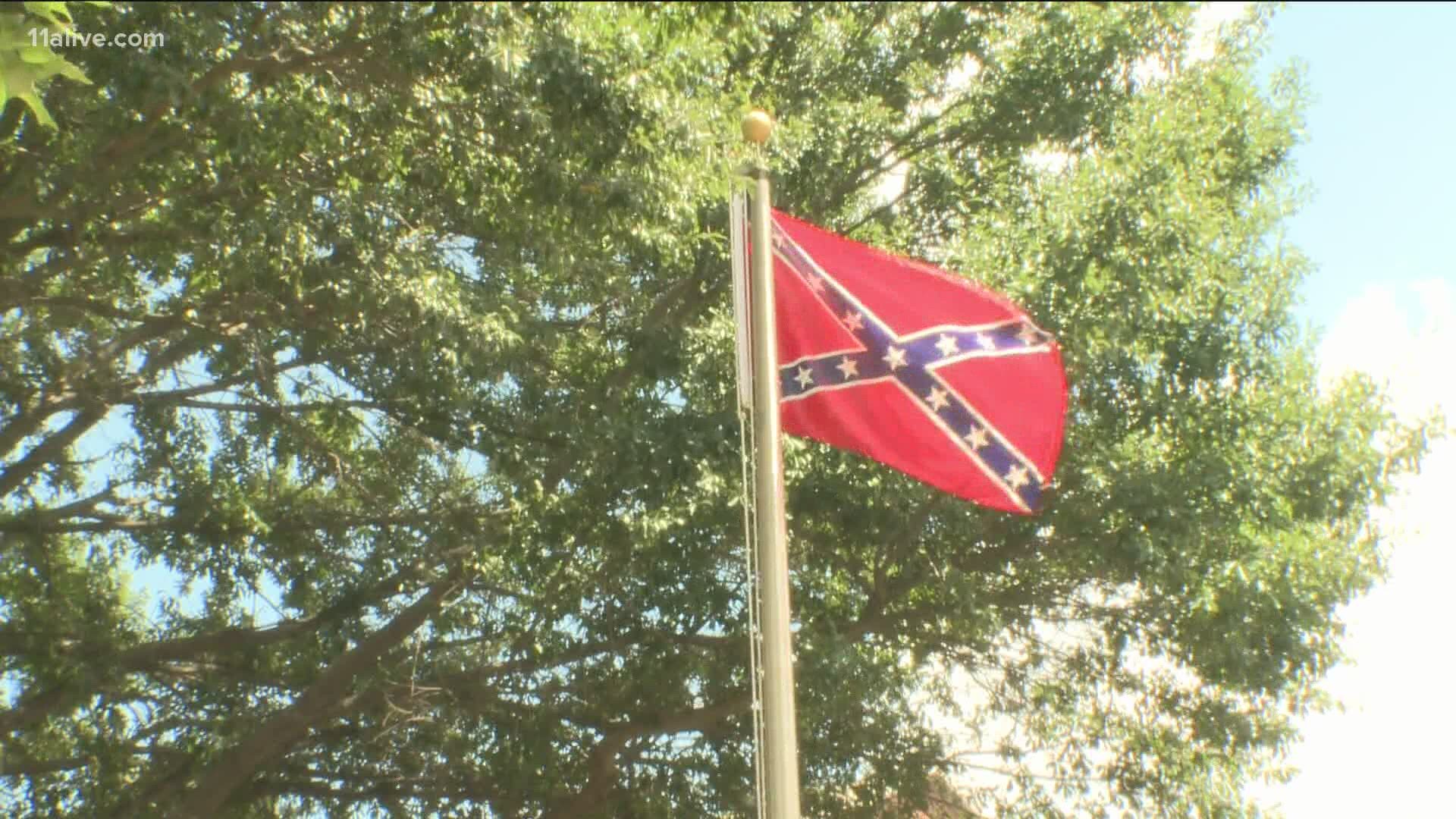 The council voted unanimously to remove the flag from its war memorial during a packed meeting.