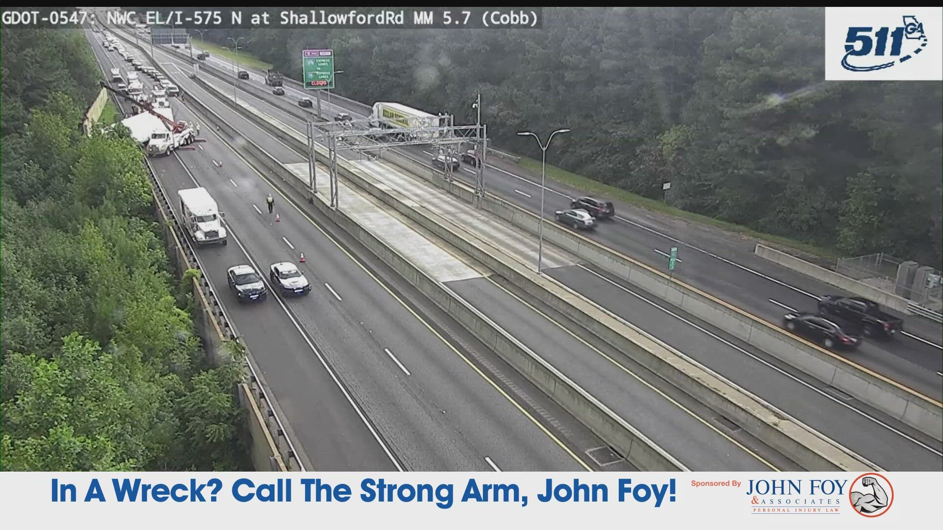 GDOT cams show a tractor-trailer off to the side of the road in the northbound lanes, which appears to be over the guardrail.