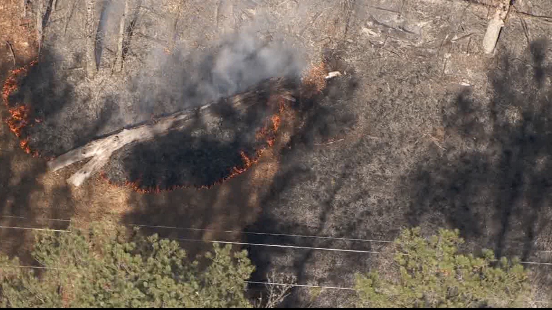 Smoke is seen billowing for miles after a large grass fire broke out near Stone Mountain Park on Monday afternoon.