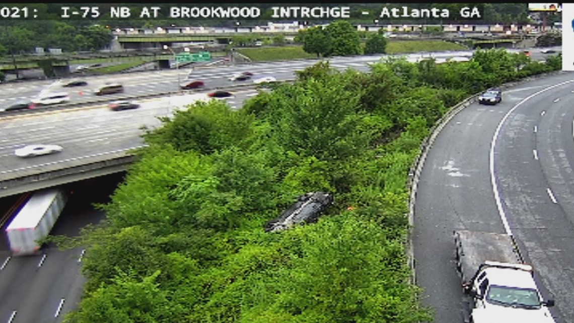 Car flips on Buford Spring Connector SB near Spring Street