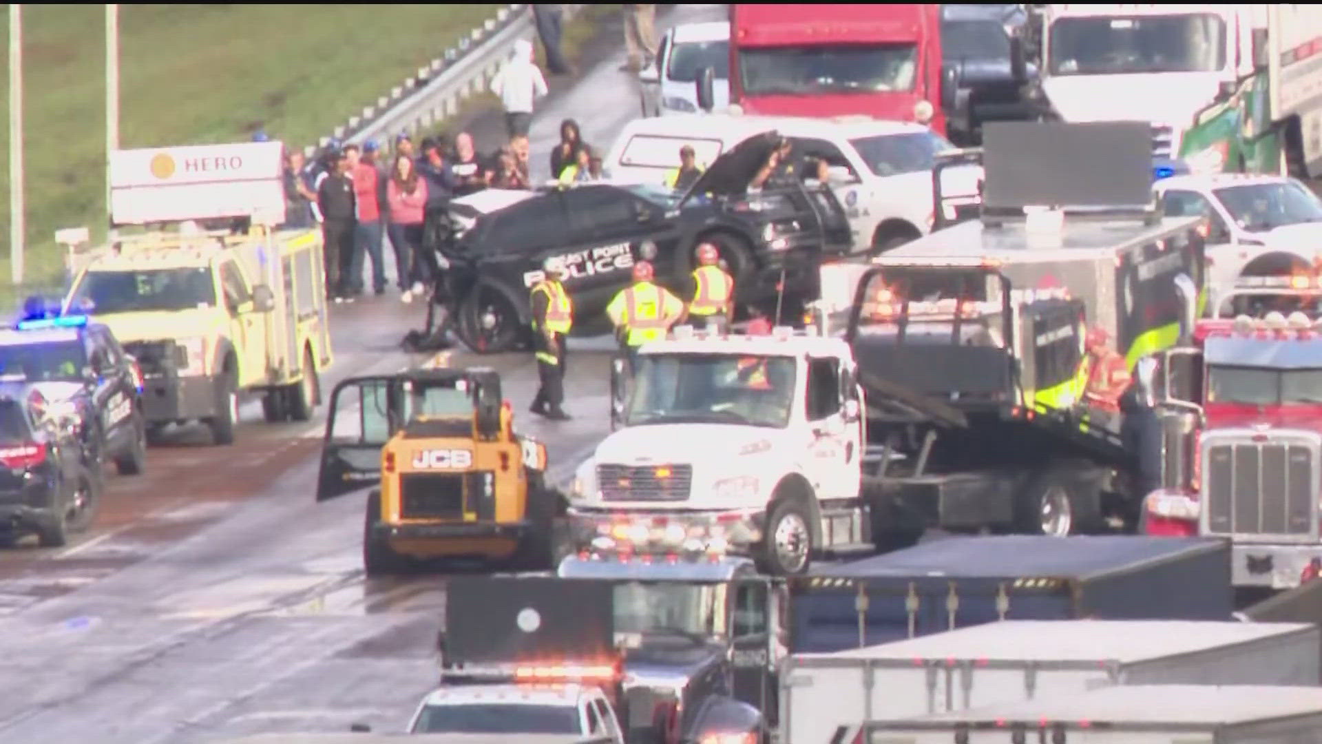 A serious crash shut down I-285 before Camp Creek Parkway early Wednesday morning, after police say a tractor-trailer driver hit three East Point Police vehicles.