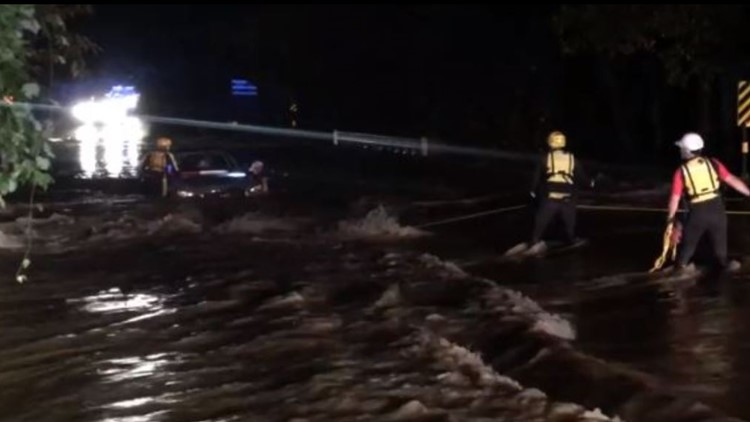 Dramatic video shows 2 people rescued after car becomes submerged by flash floods