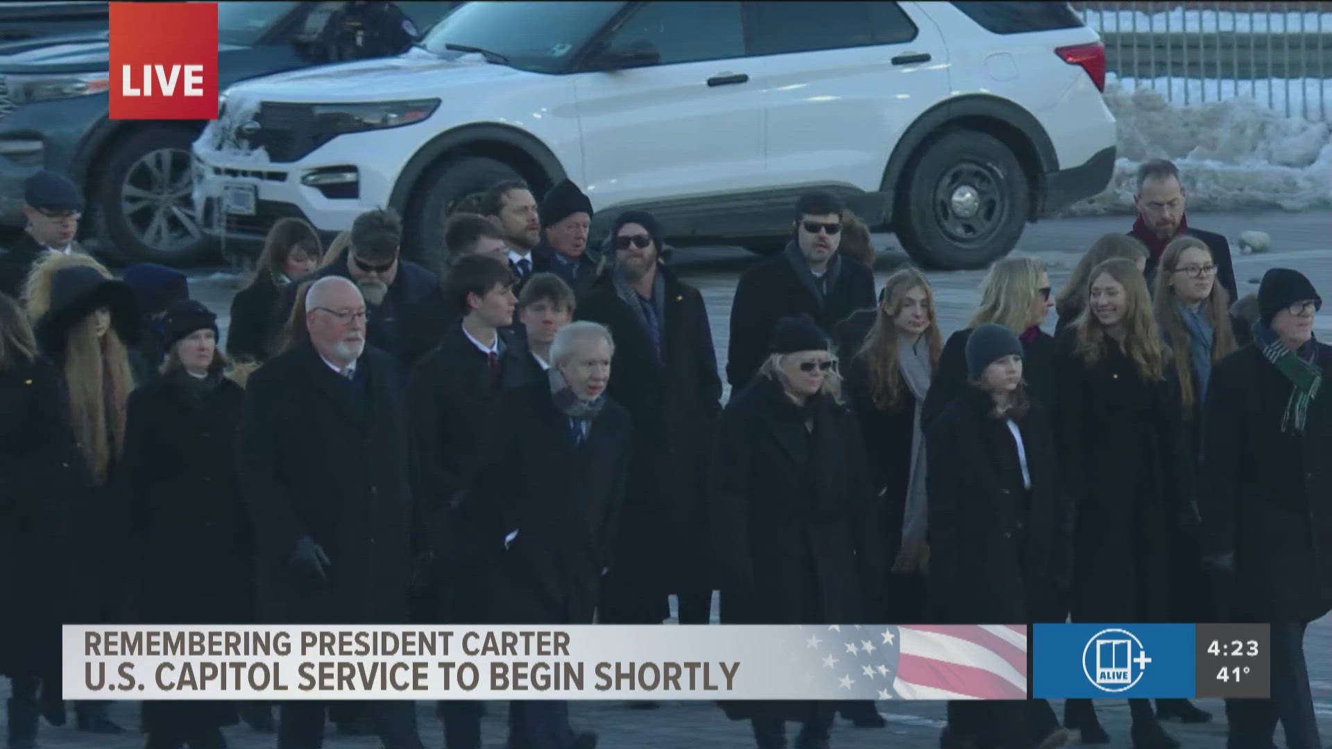 Carter family walks alongside horsedrawn carriage Honoring President