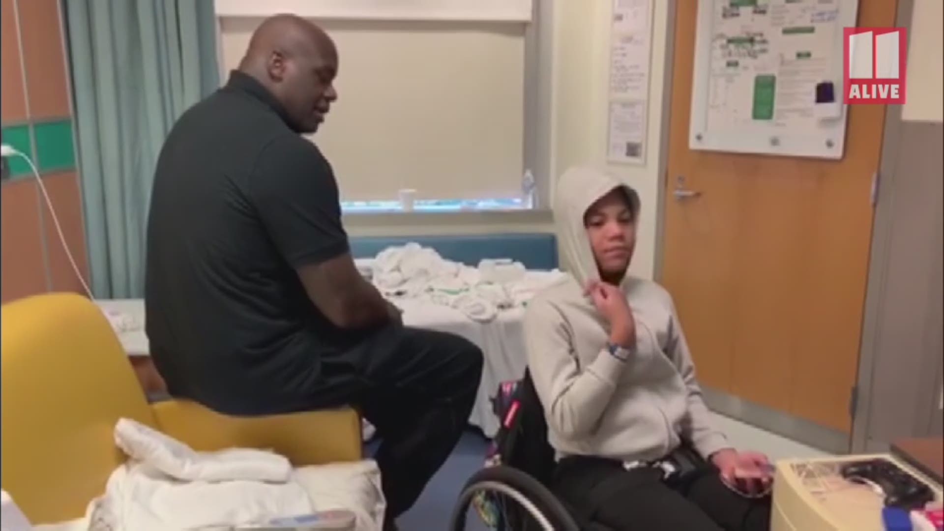 Shaquille O'Neal visits with 12-year-old Isaiah Payton at the hospital. A bullet has struck Isaiah's spine, leaving him unable to walk.